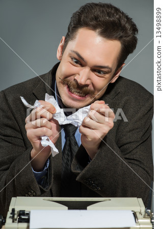 Inspired author throwing crumpled paper Inspired author throwing crumpled paper 13498899