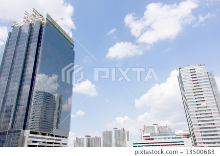 Building reflected in windows of modern office building against Building reflected in windows of modern office building against 13500683