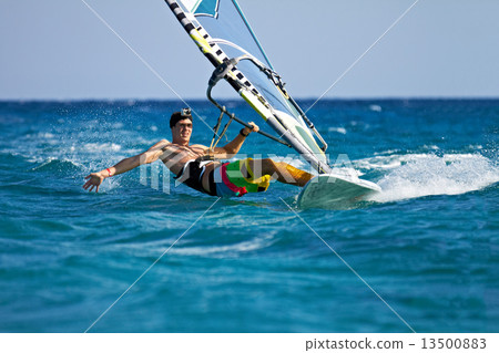 Young man surfing the wind in splashes of water 13500883