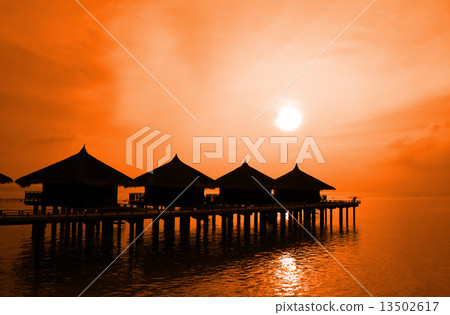 Sunset and water bungalows 13502617
