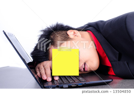 young business man sleeping on his laptop with paper note 13504850