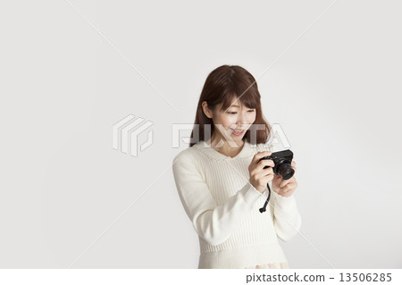 A woman glad that a good photo can be taken with a compact digital camera 13506285