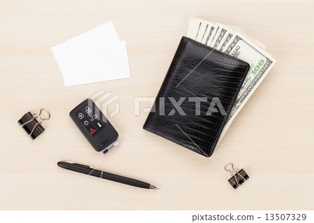 Money cash wallet and car remote key on wooden table 13507329