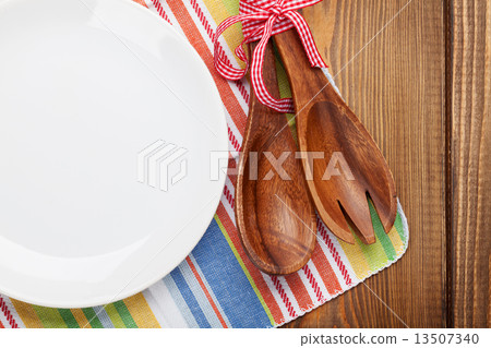 Wood kitchen utensils over wooden table 13507340