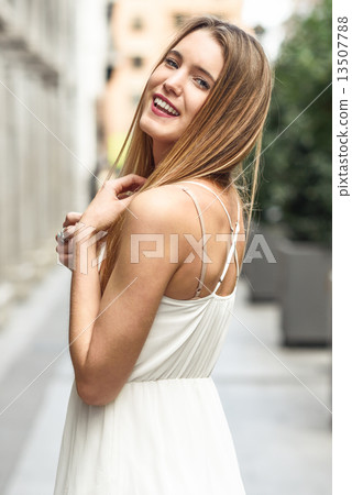 Beautiful blonde girl in urban background 13507788