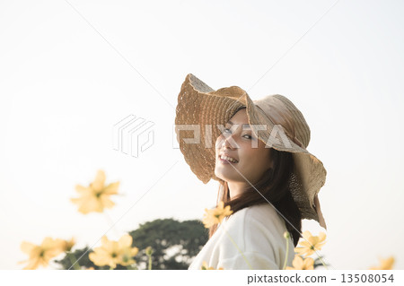 Asian girl smiling in the flower garden Asian girl smiling in the flower garden 13508054