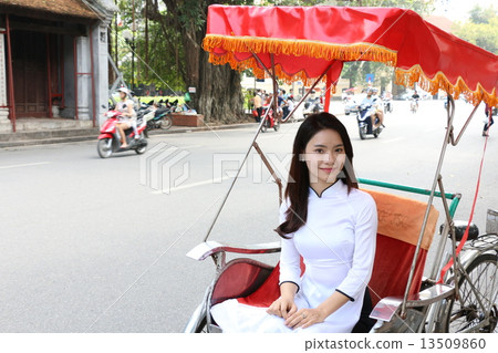 Ao girl riding a Vietnam Hanoi Cycle 13509860