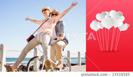 Composite image of happy casual couple going for a bike ride on 13510585