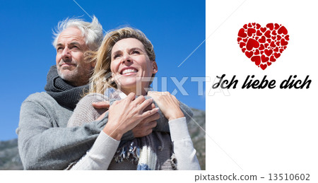 Composite image of carefree couple hugging in warm clothing Composite image of carefree couple hugging in warm clothing 13510602