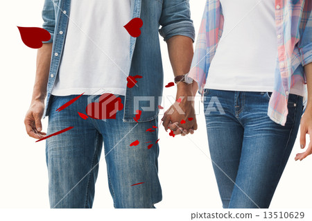 Composite image of hip young couple holding hands Composite image of hip young couple holding hands 13510629
