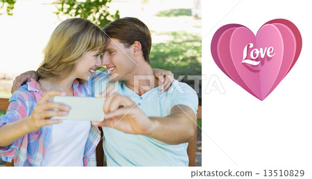 Composite image of smiling couple sitting on bench in the park t 13510829