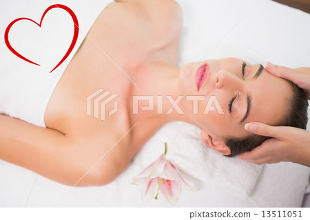 Composite image of attractive woman receiving head massage at sp Composite image of attractive woman receiving head massage at sp 13511051