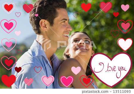 Composite image of loving and happy young couple at park Composite image of loving and happy young couple at park 13511093