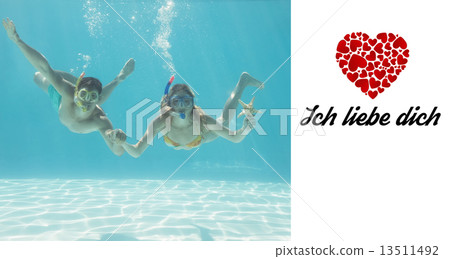 Composite image of cute couple underwater in the swimming pool w 13511492
