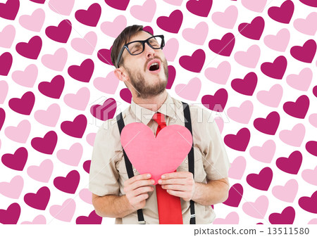 Composite image of geeky hipster crying and holding heart card 13511580