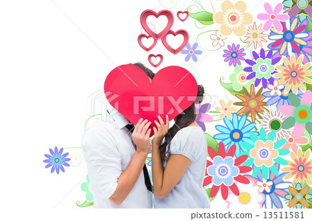 Composite image of couple covering their kiss with a heart Composite image of couple covering their kiss with a heart 13511581