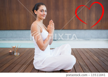 Composite image of content brunette in white sitting in lotus po 13511841