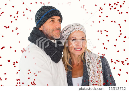 Composite image of happy couple in winter fashion embracing 13512712