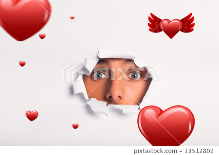 Composite image of young man looking through paper rip 13512802