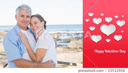 Composite image of happy casual couple embracing by the sea 13512910