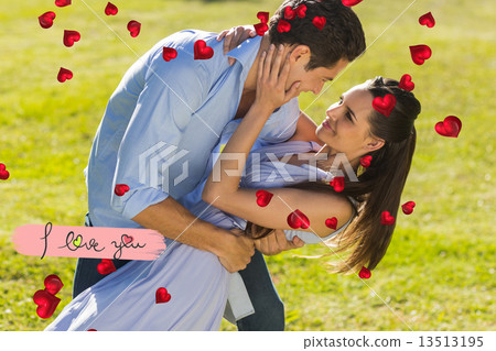 Composite image of loving and happy couple dancing in park Composite image of loving and happy couple dancing in park 13513195