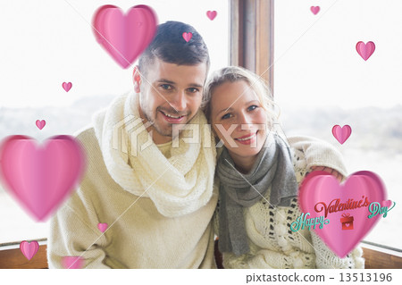 Composite image of couple in winter clothing sitting against win 13513196