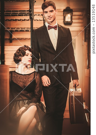 Vintage style couple inside retro train coach 13519148