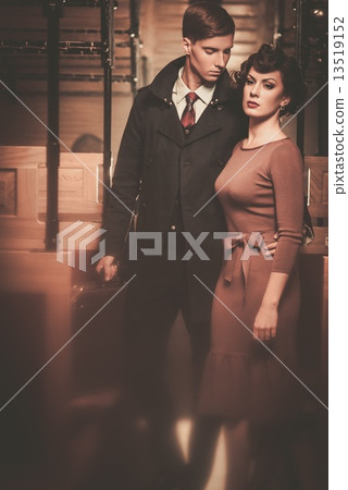 Vintage style couple inside retro train coach 13519152
