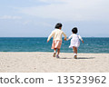 Sister heading to the sea at the sandy beach 13523962
