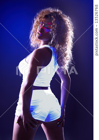 Sexy girl posing in luminous clothes under UV  13526768