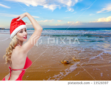 The young woman in the New Year's cap on a beach 13528397