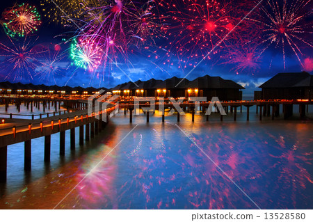 Festive New Year's fireworks over the tropical island 13528580