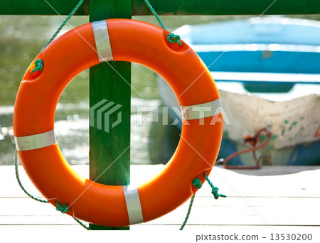 Lifebuoy at the mooring and the boat on a background 13530200