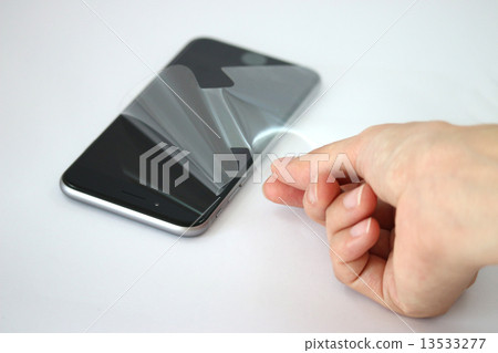 The moment of taking a protective film of a smartphone 13533277