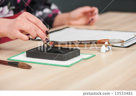 Traditional calligraphy on wooden table Traditional calligraphy on wooden table 13533481