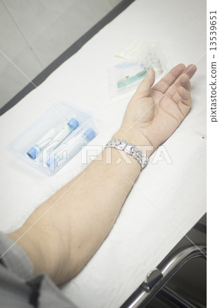 Nurse and male patient blood sample donation 13539651