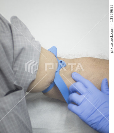 Nurse and male patient blood sample donation 13539652