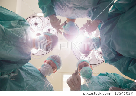 Medical students practicing surgery on model Medical students practicing surgery on model 13545037