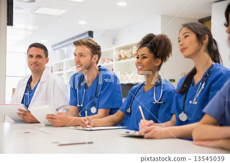 Medical student smiling at the camera during class 13545039