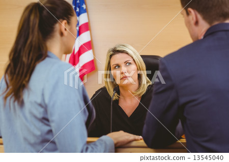 Judge and lawyers speaking in front of the american flag Judge and lawyers speaking in front of the american flag 13545040