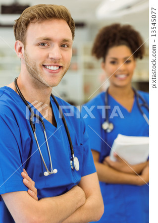 Young medical students smiling at the camera 13545077