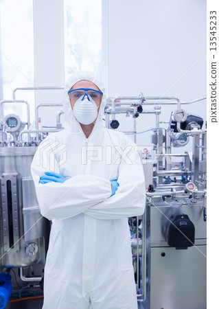 Scientist in protective suit standing with arms crossed 13545233