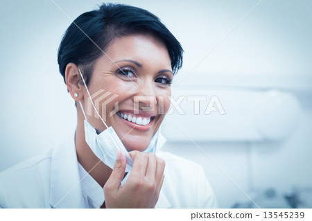 Confident female dentist smiling Confident female dentist smiling 13545239