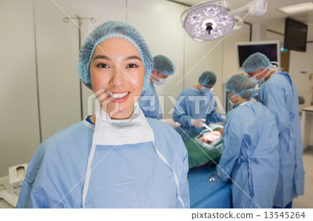 Medical students practicing surgery on model Medical students practicing surgery on model 13545264