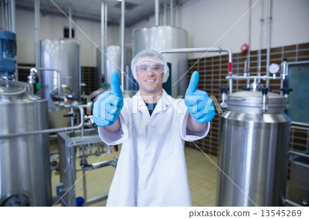 Positive man in lab coat giving thumbs up Positive man in lab coat giving thumbs up 13545269