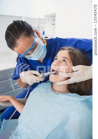 Pediatric dentist wearing safety glasses Pediatric dentist wearing safety glasses 13545478