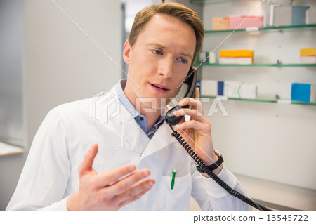Serious pharmacist on the phone 13545722