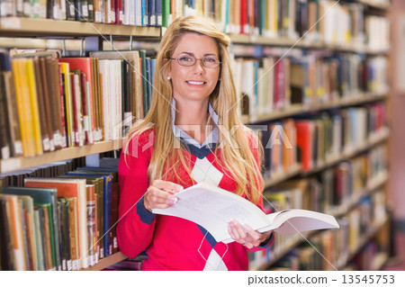 Mature student studying in the library Mature student studying in the library 13545753