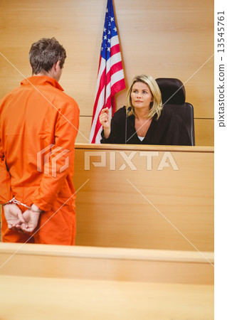 Judge and criminal speaking in front of the american flag 13545761