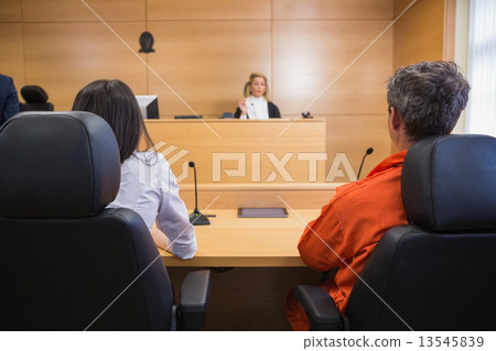 Lawyer and client listening to judge 13545839
